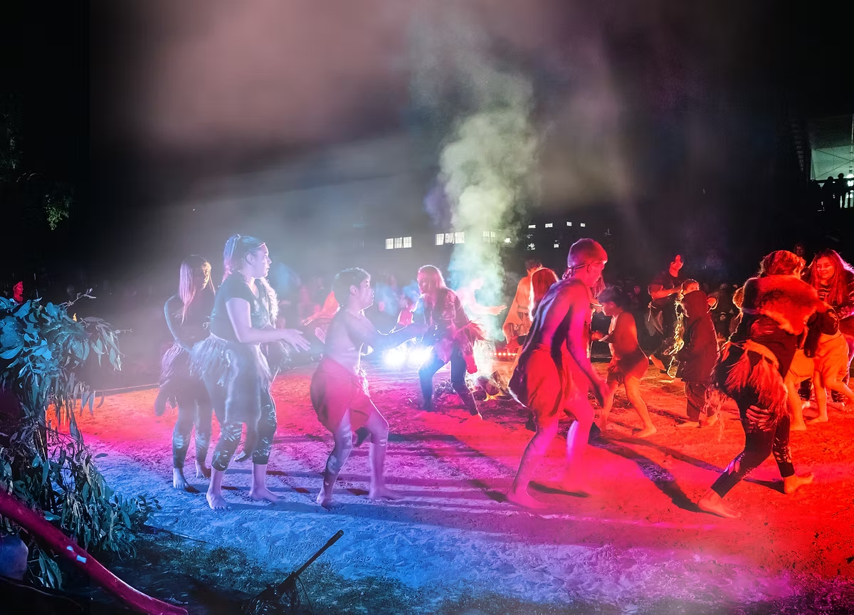 Wadawurrung dancers performing around a ceremonial fire at night