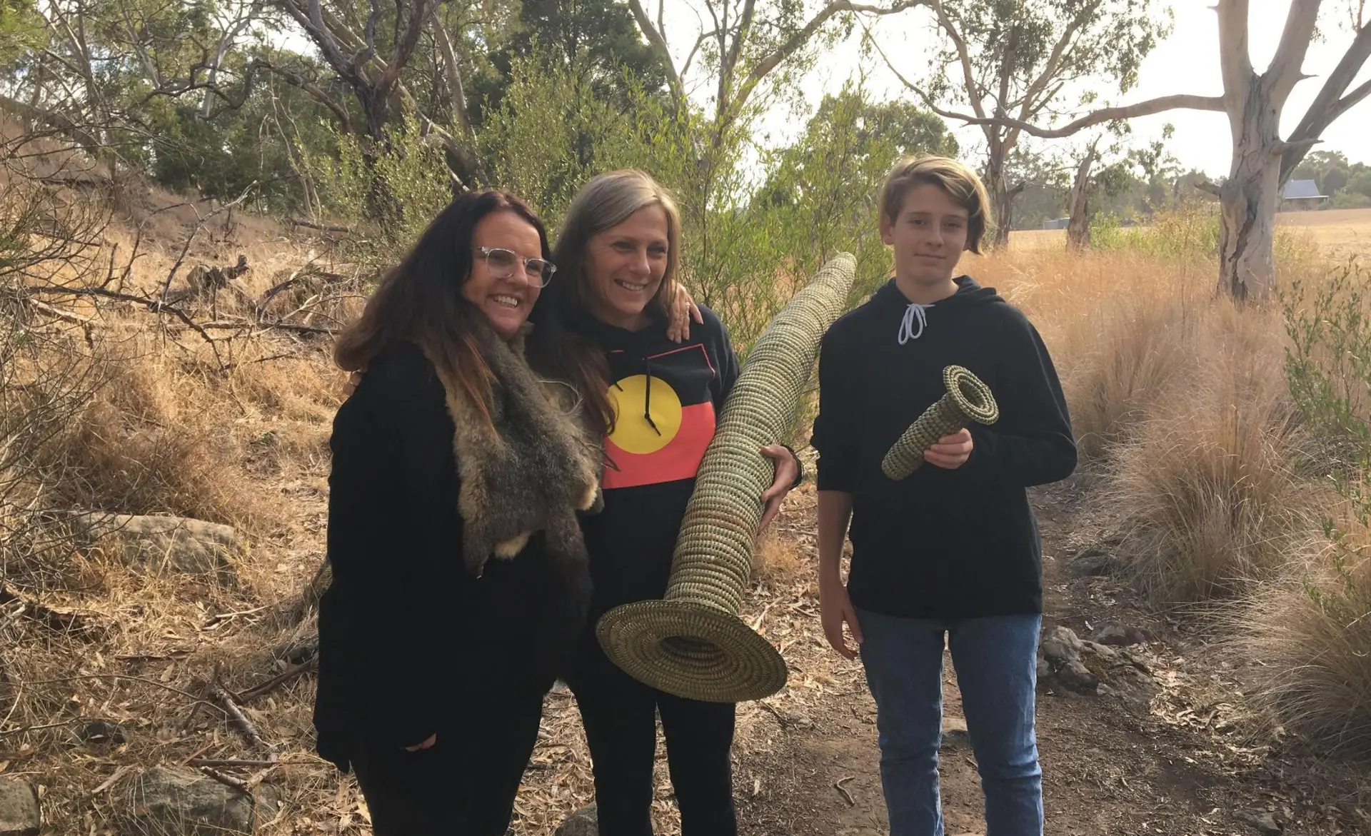 Wadawurrung community members holding woven eel traps on Country